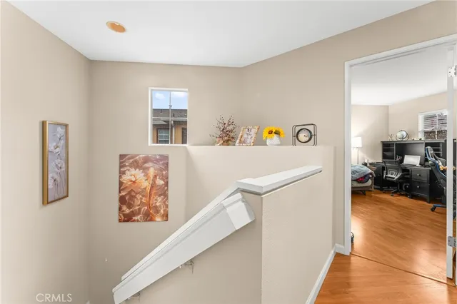 a view of a hallway with workspace and a window