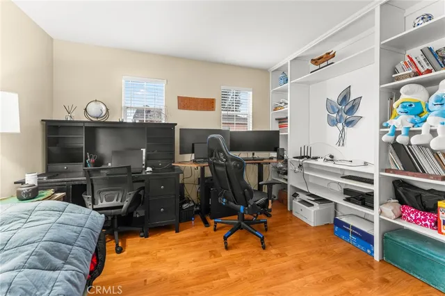 a bedroom with furniture and a flat screen tv