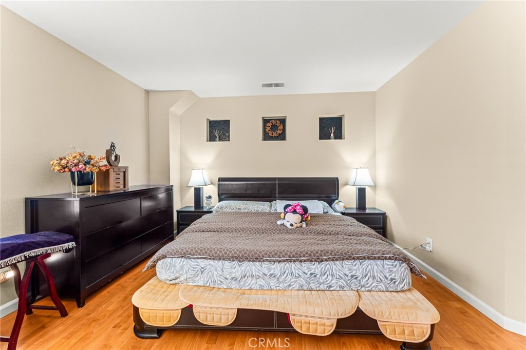 1560 Firestone Loop San Jose, CA 95116 - Photo 18 of 33 a bedroom with a bed and wooden floor