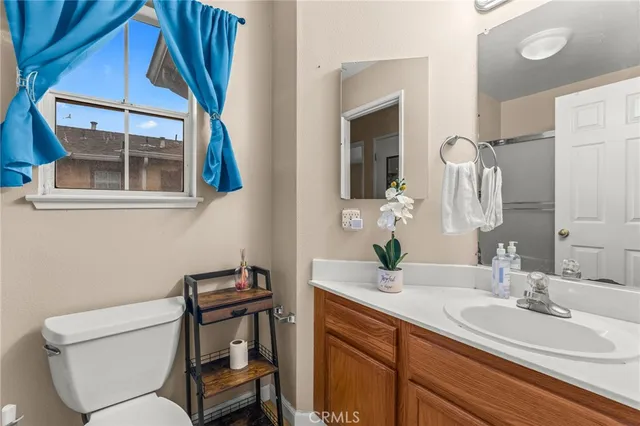 a bathroom with a toilet a sink and mirror