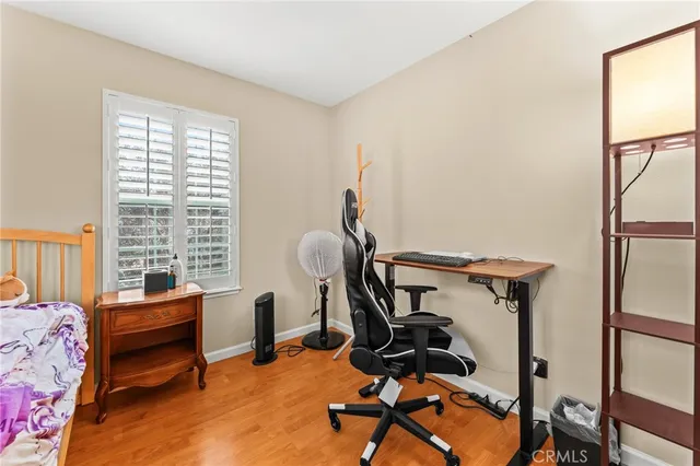 a view of a workspace with furniture and a window