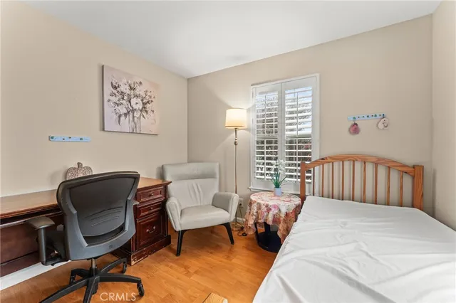 a bedroom with a bed chair and a window