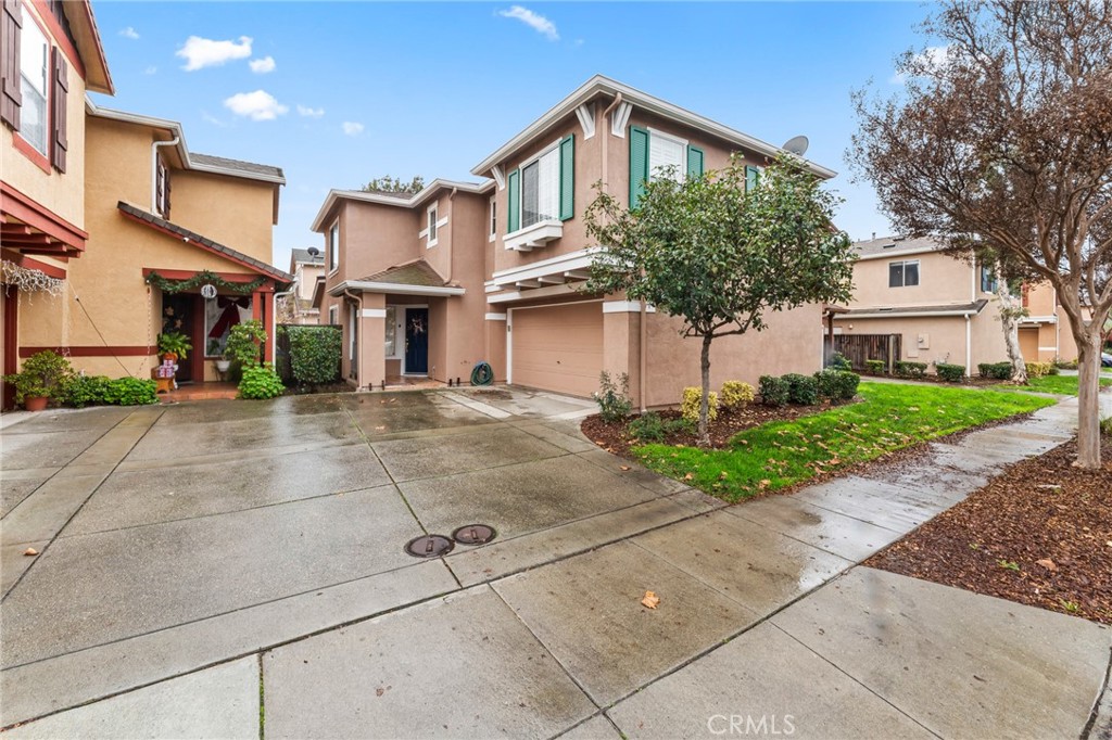1560 Firestone Loop San Jose, CA 95116 - Photo 29 of 33 a front view of a house with a yard and potted plants