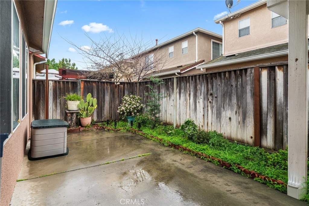 1560 Firestone Loop San Jose, CA 95116 - Photo 32 of 33 a backyard of a house with plants and outdoor seating