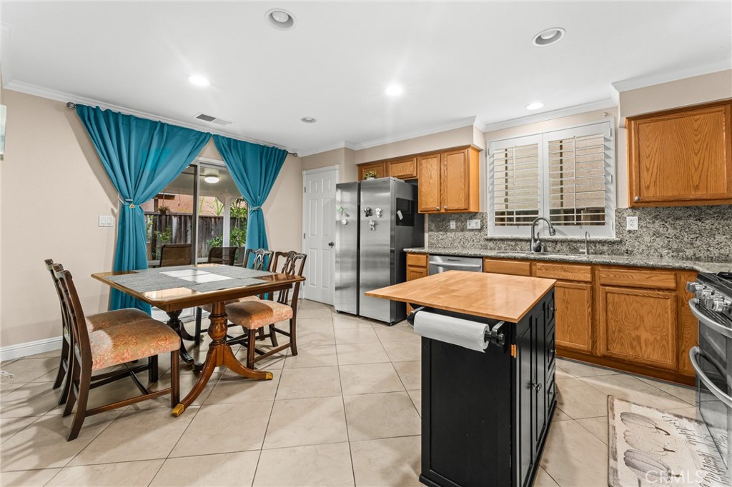 1560 Firestone Loop San Jose, CA 95116 - Photo 6 of 33 a kitchen with stainless steel appliances granite countertop table chairs sink and window
