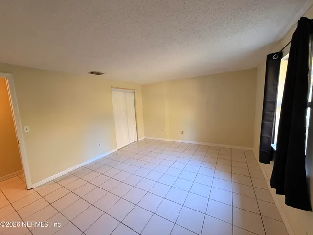 a view of an empty room and a window