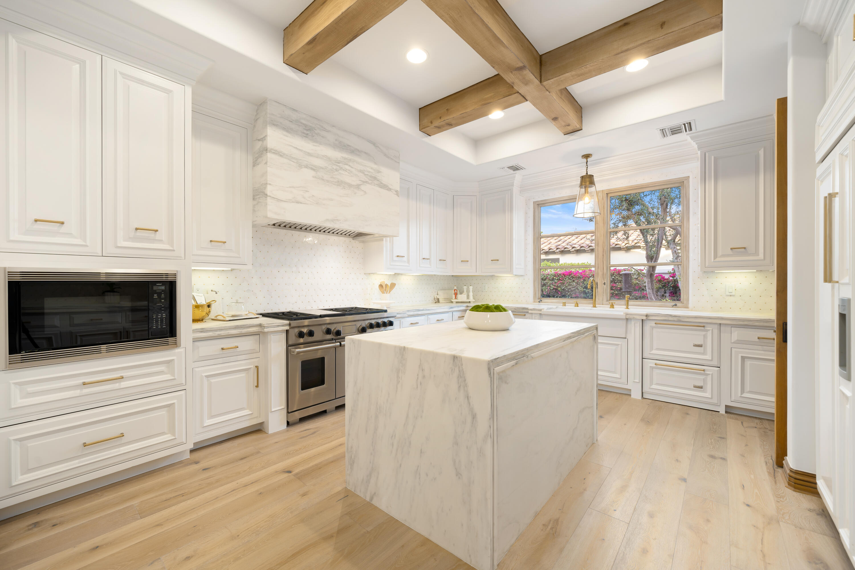 80820 Via Portofino La Quinta, CA 92253 - Photo 21 of 52 a kitchen with granite countertop a sink a stove and cabinets