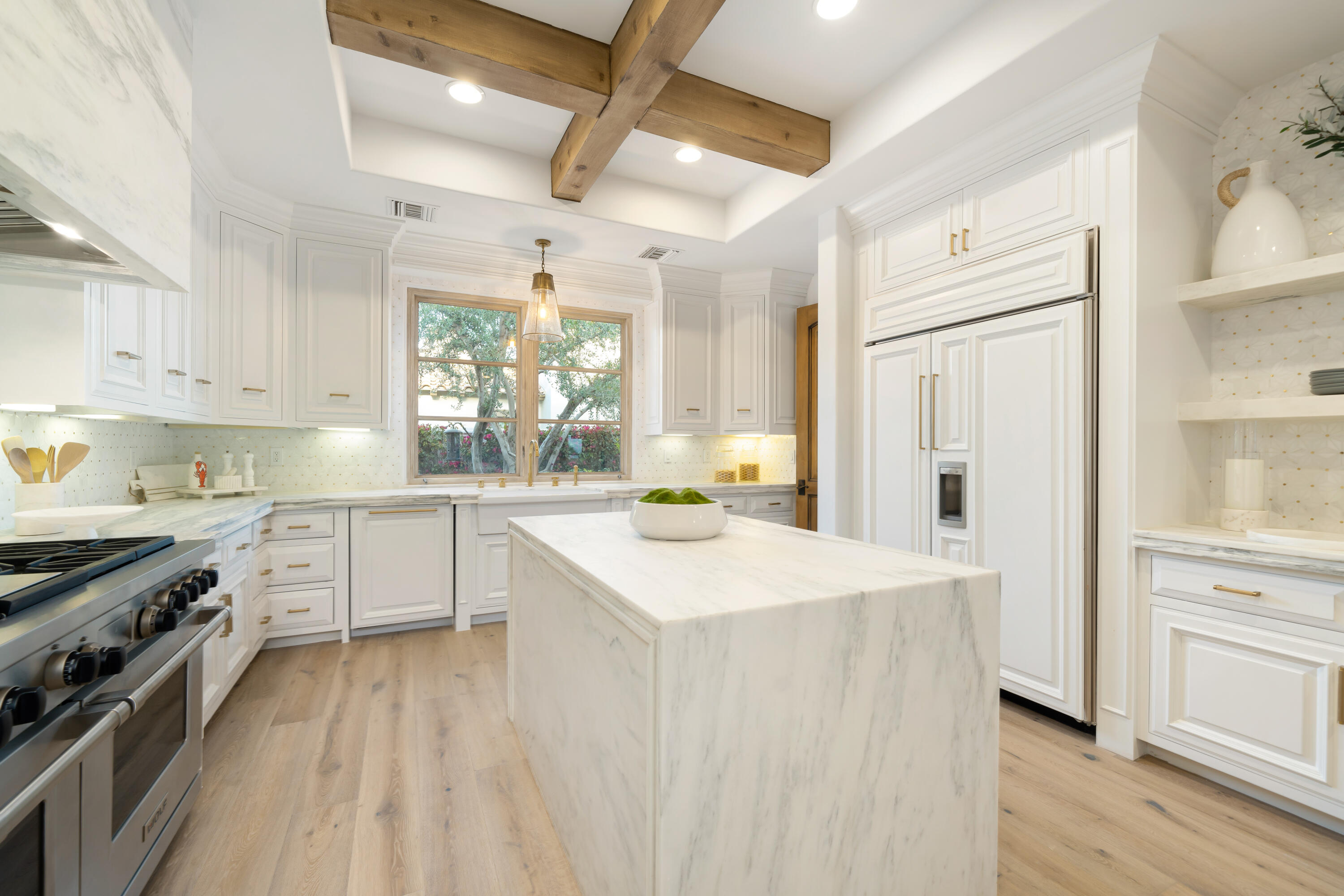 80820 Via Portofino La Quinta, CA 92253 - Photo 22 of 52 a kitchen with a sink stove and white cabinets