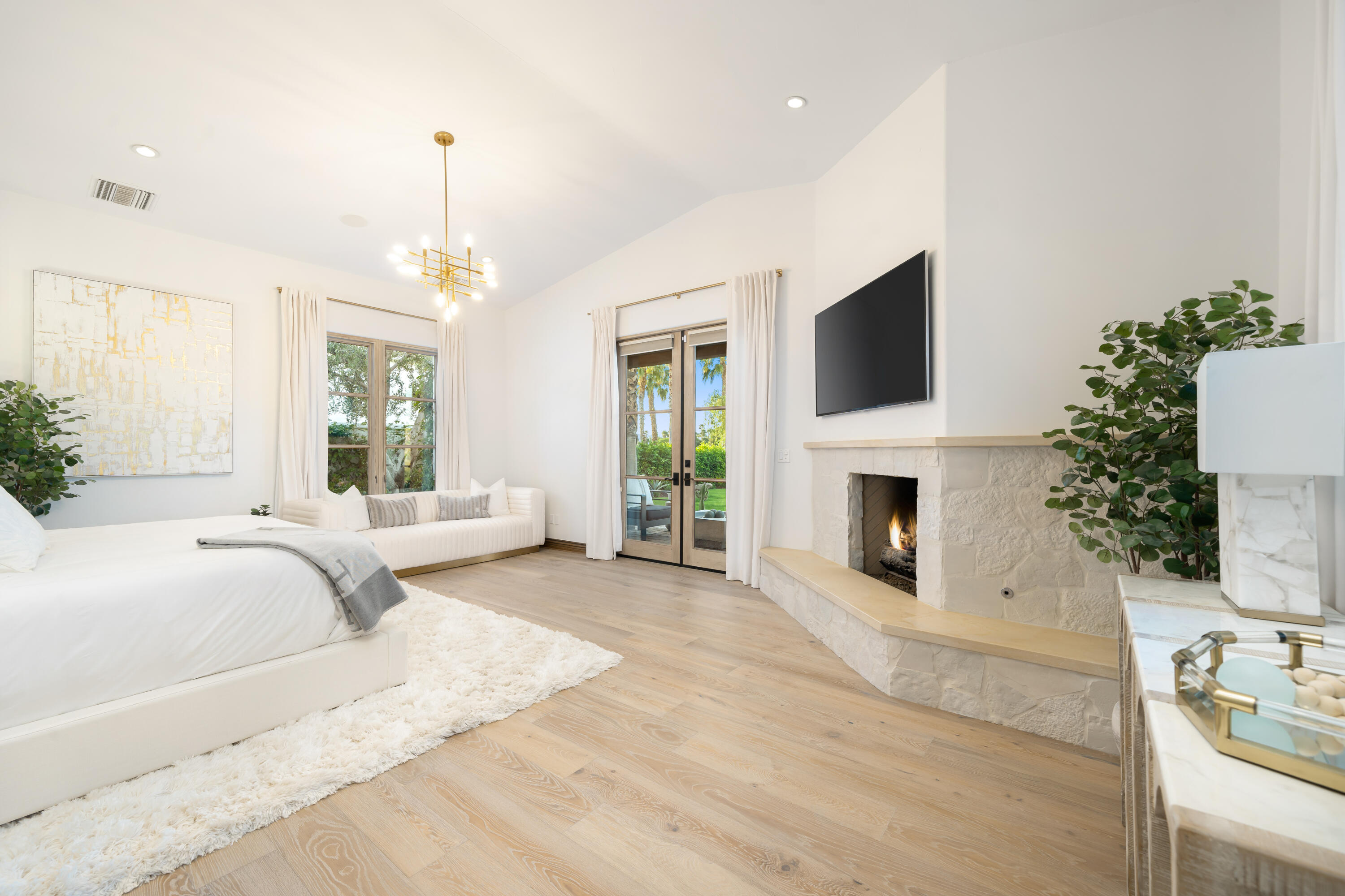 80820 Via Portofino La Quinta, CA 92253 - Photo 24 of 52 a spacious bedroom with a large bed and a fireplace