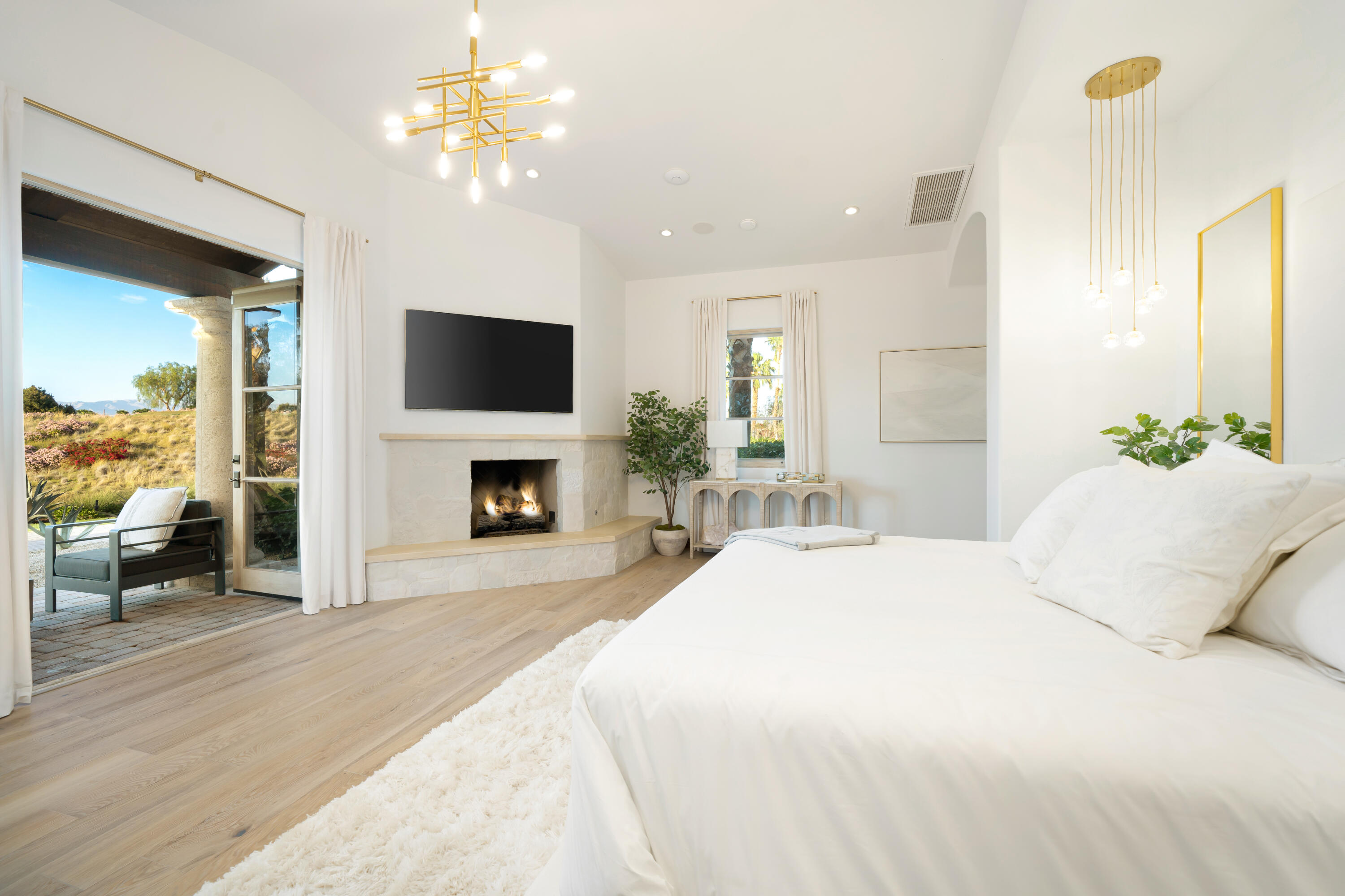 80820 Via Portofino La Quinta, CA 92253 - Photo 26 of 52 a bedroom with a bed and a fireplace