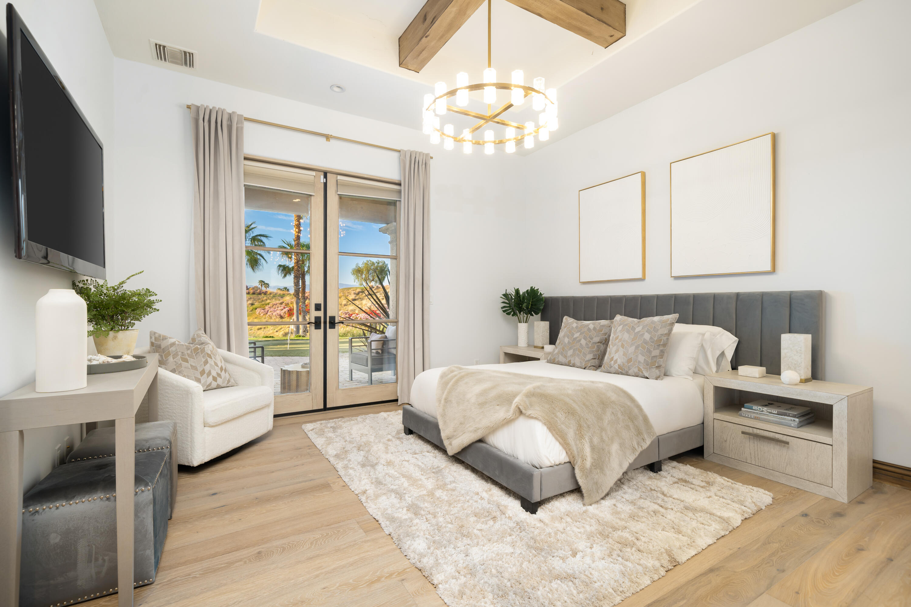 80820 Via Portofino La Quinta, CA 92253 - Photo 36 of 52 a bedroom with a large bed and a chandelier