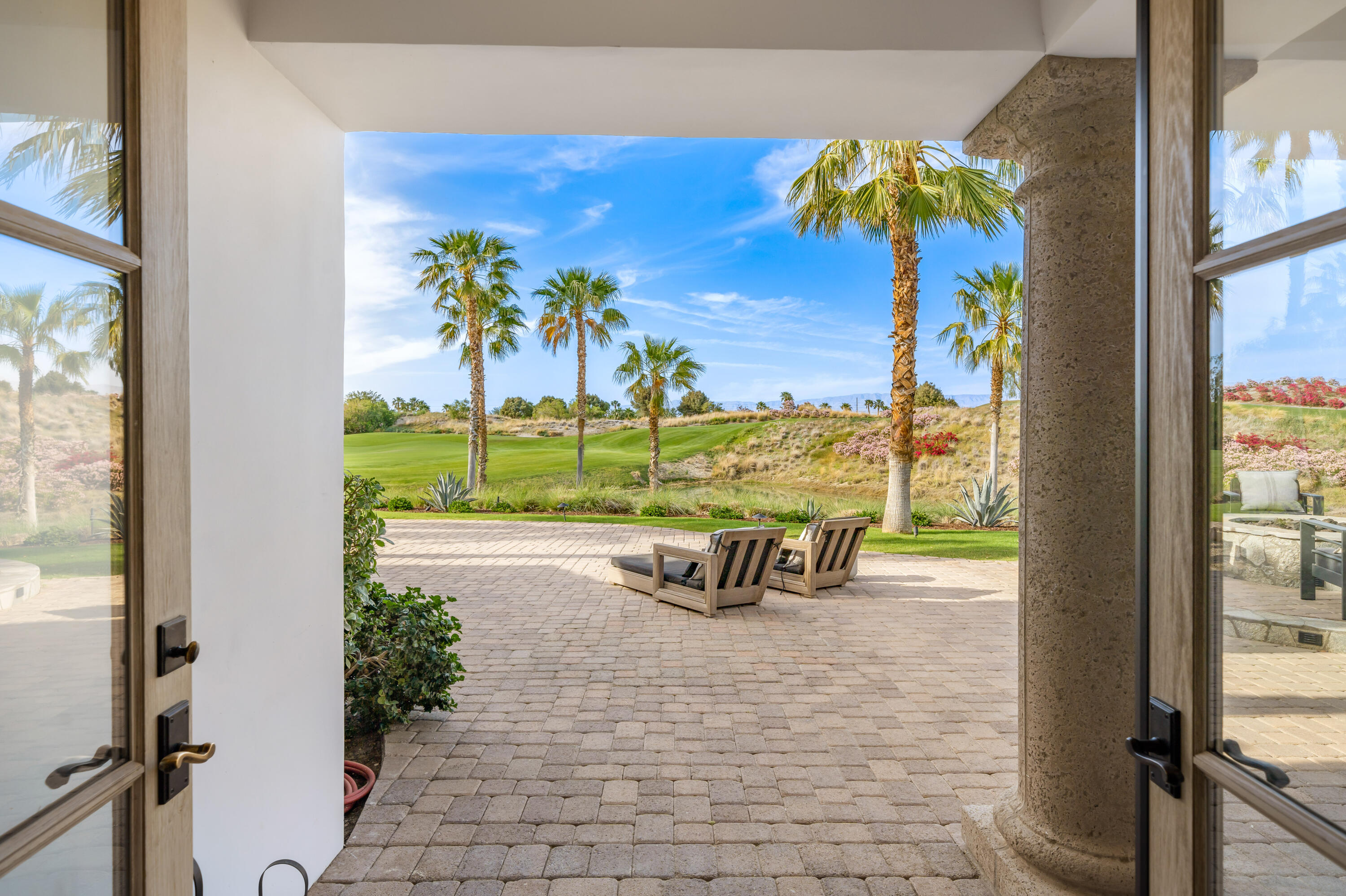 80820 Via Portofino La Quinta, CA 92253 - Photo 44 of 52 a view of a swimming pool with a lounge chair and a floor to ceiling window