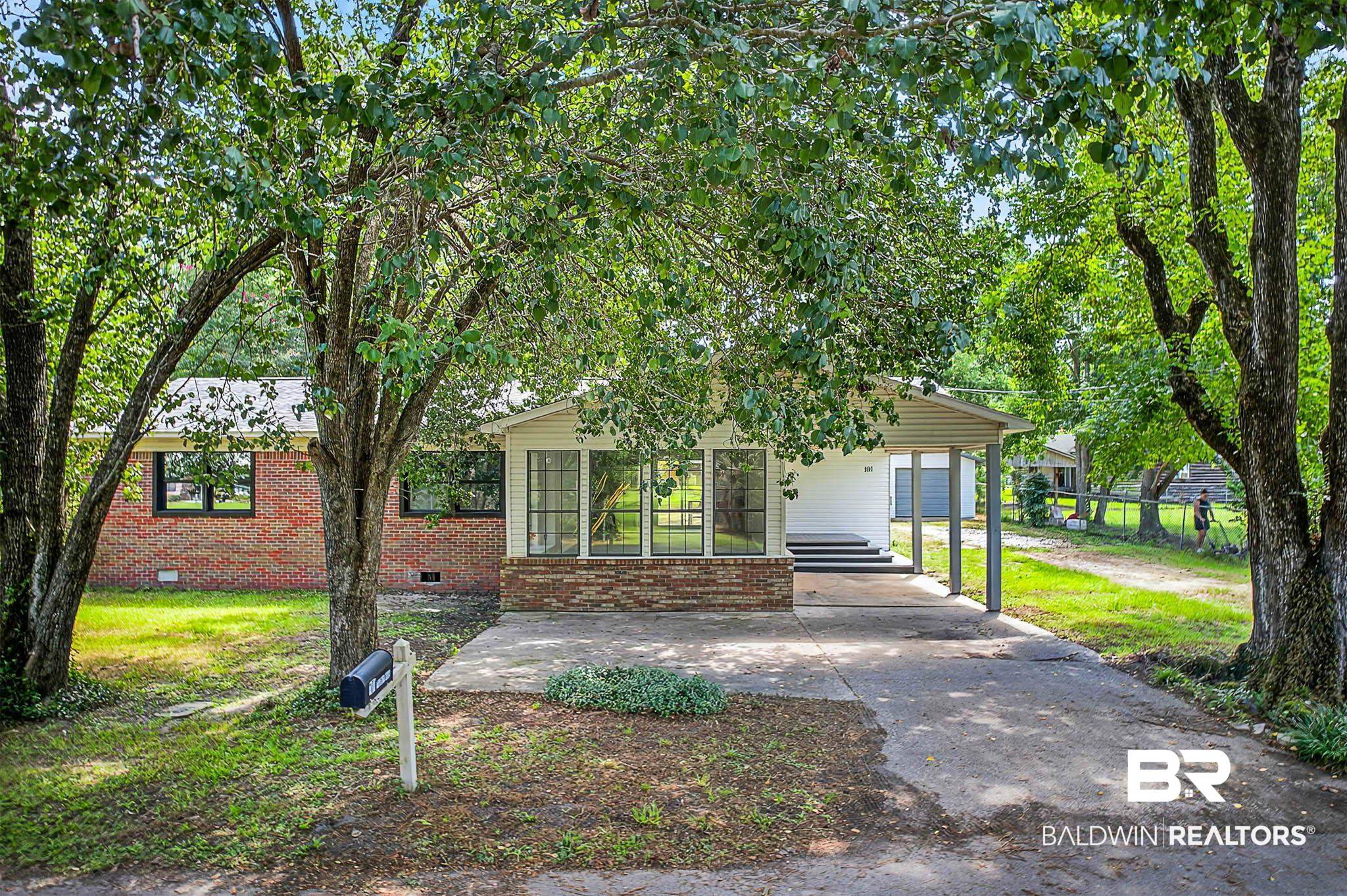 101 Terry Avenue Brewton, AL 36426 - Photo 19 of 48 View of front of house with concrete driveway, crawl space, brick siding, and an attached carport