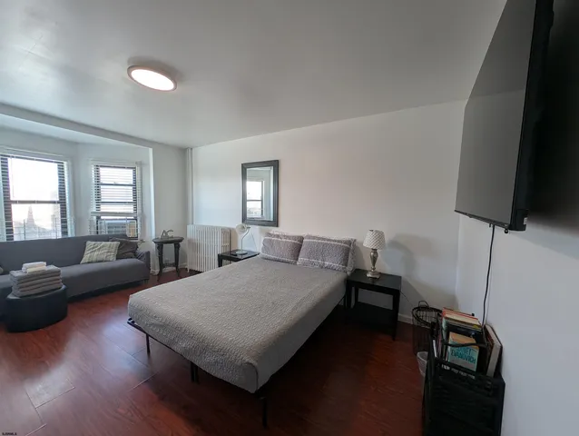 a bedroom with a bed and a couch