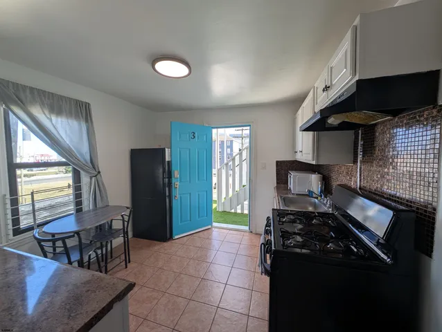 a kitchen with a sink a stove and a refrigerator
