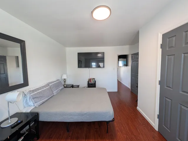 a living room with a table and a flat screen tv