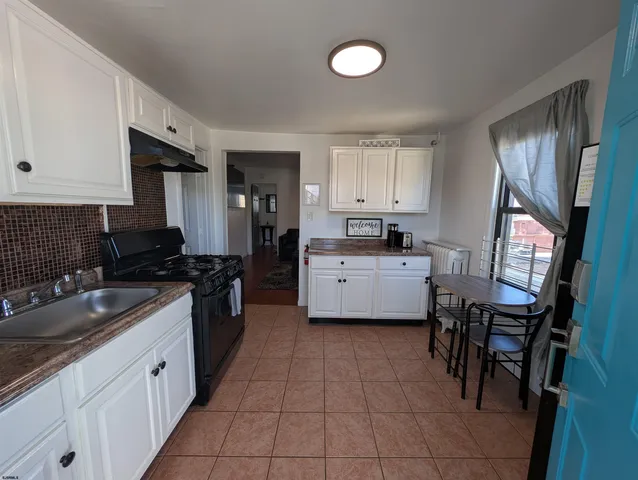 a kitchen with a sink cabinets and window