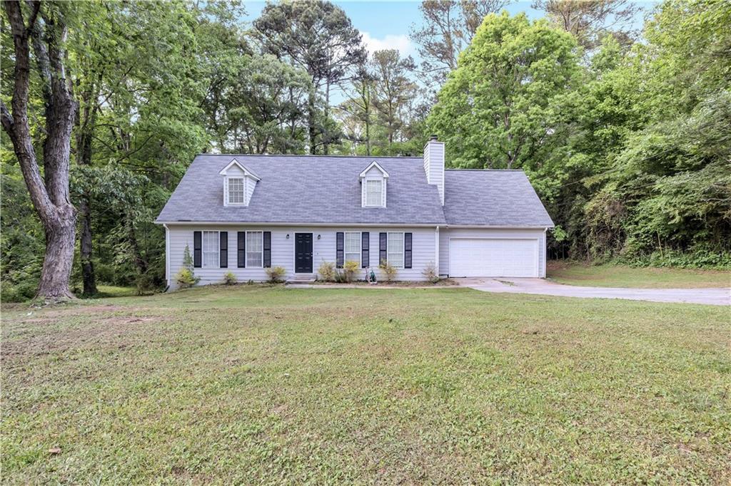901 Timbervale Lane Lithonia, GA 30058 - Photo 1 of 1 a view of a yard in front of a house with large tree