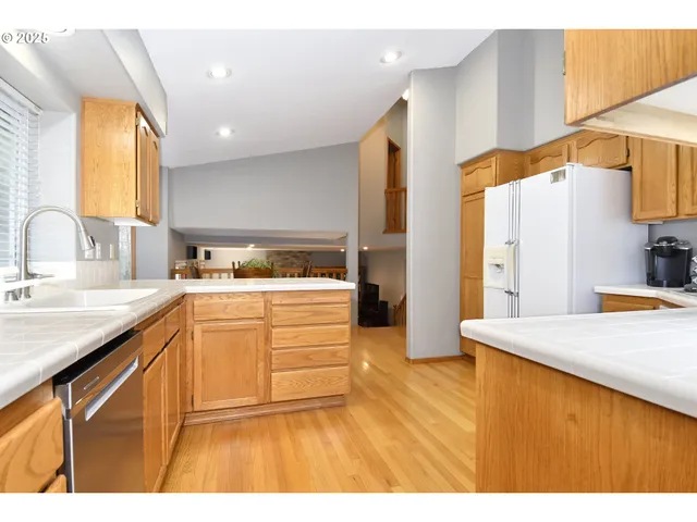 a kitchen with kitchen island a sink stainless steel appliances and cabinets