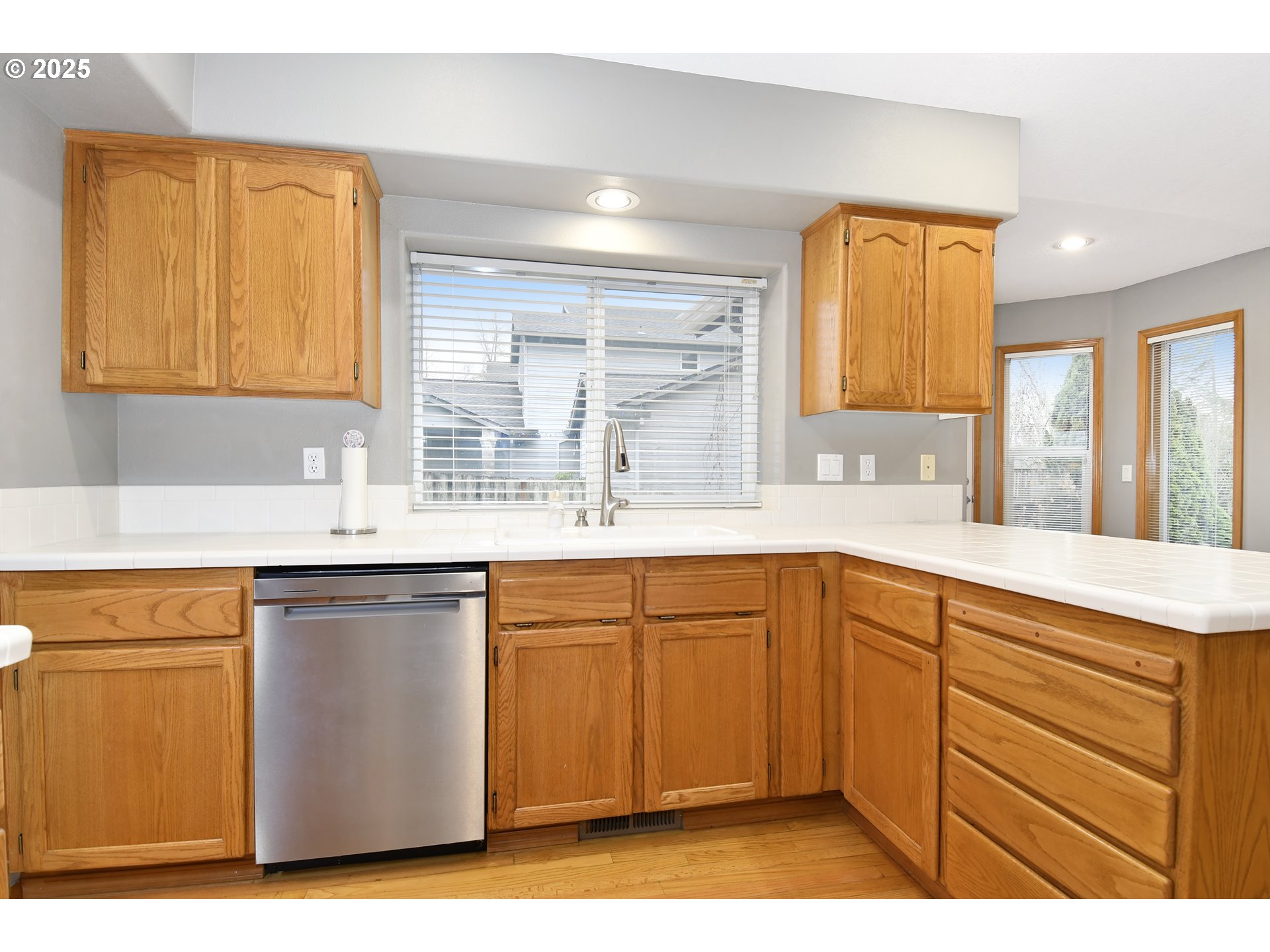 4396 Southeast 1st Terrace Gresham, OR 97080 - Photo 13 of 36 a kitchen with granite countertop a sink cabinets and wooden floor