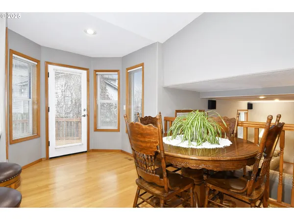 a dining room with furniture and a large window