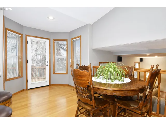 a dining room with furniture and a large window