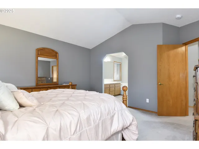 a bathroom with a tub a sink and mirror