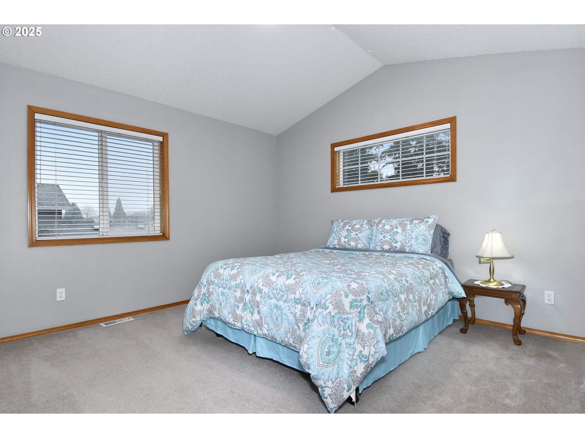 4396 Southeast 1st Terrace Gresham, OR 97080 - Photo 28 of 36 a bedroom with a bed and a lamp with window