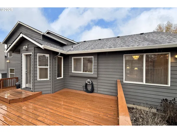 a view of a house with a wooden deck