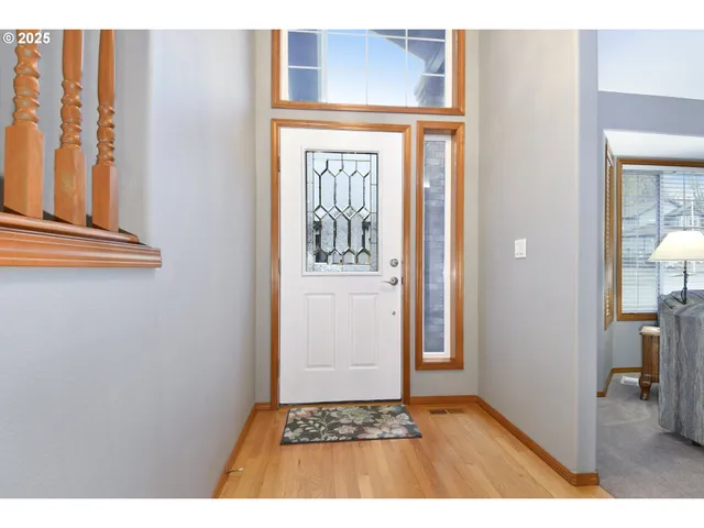 a view of an entryway with wooden floor