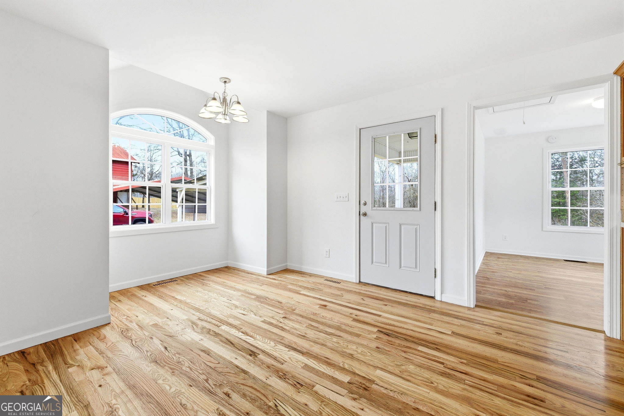 1429 Crumps Bridge Road Martin, GA 30557 - Photo 15 of 54 an empty room with wooden floor and windows