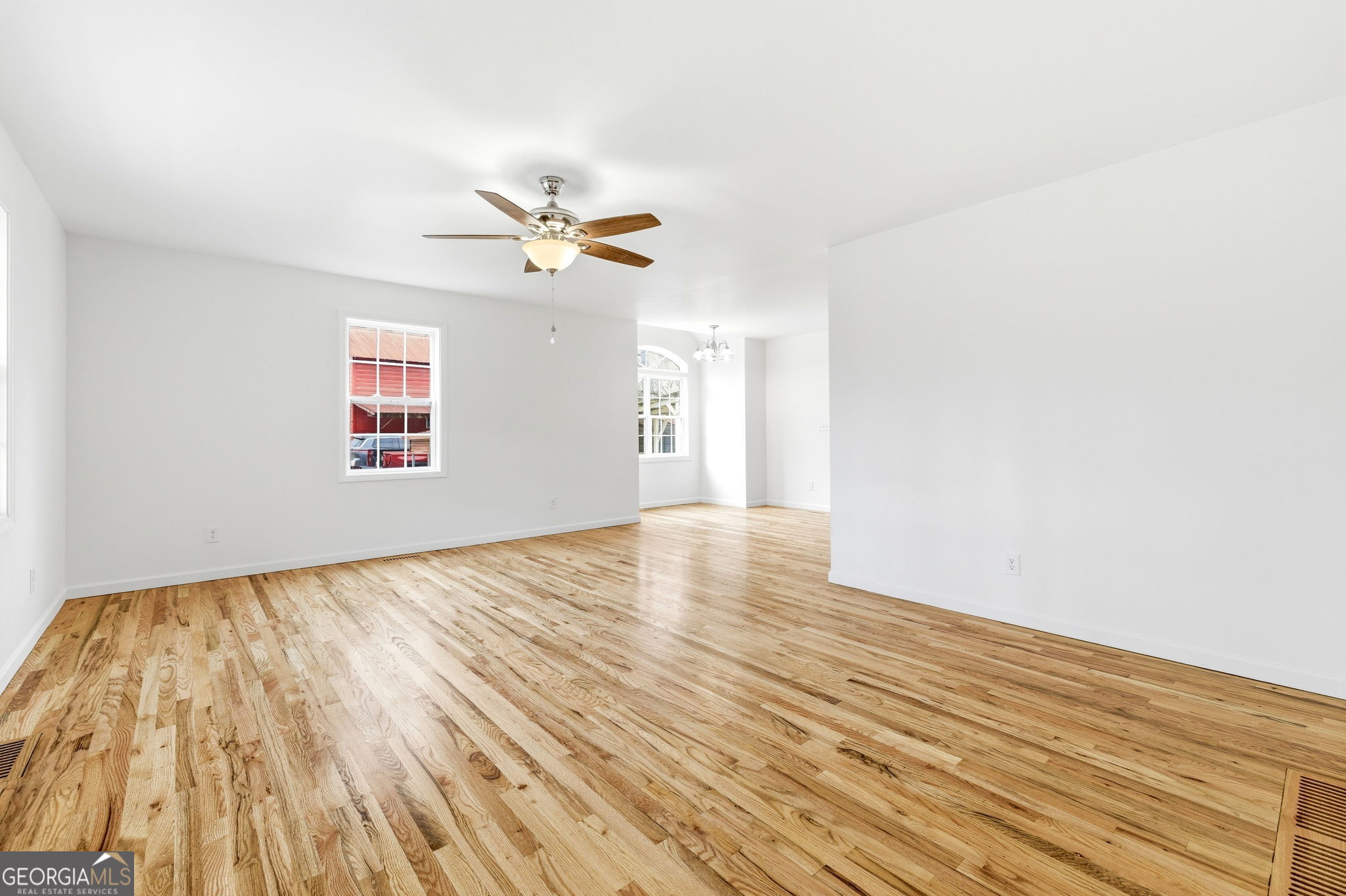 1429 Crumps Bridge Road Martin, GA 30557 - Photo 17 of 54 a view of empty room with wooden floor and fan
