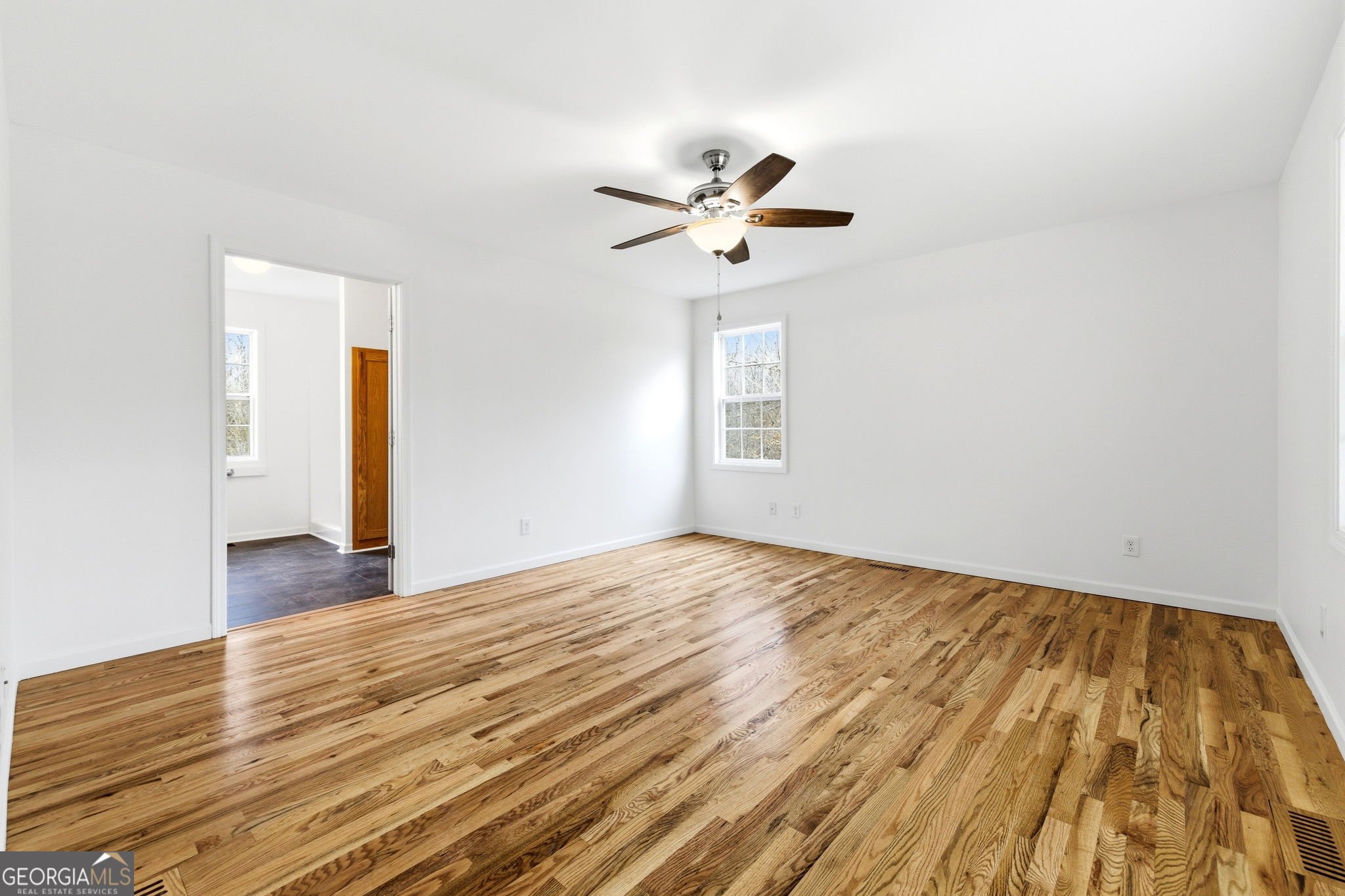1429 Crumps Bridge Road Martin, GA 30557 - Photo 23 of 54 a view of empty room with wooden floor and fan