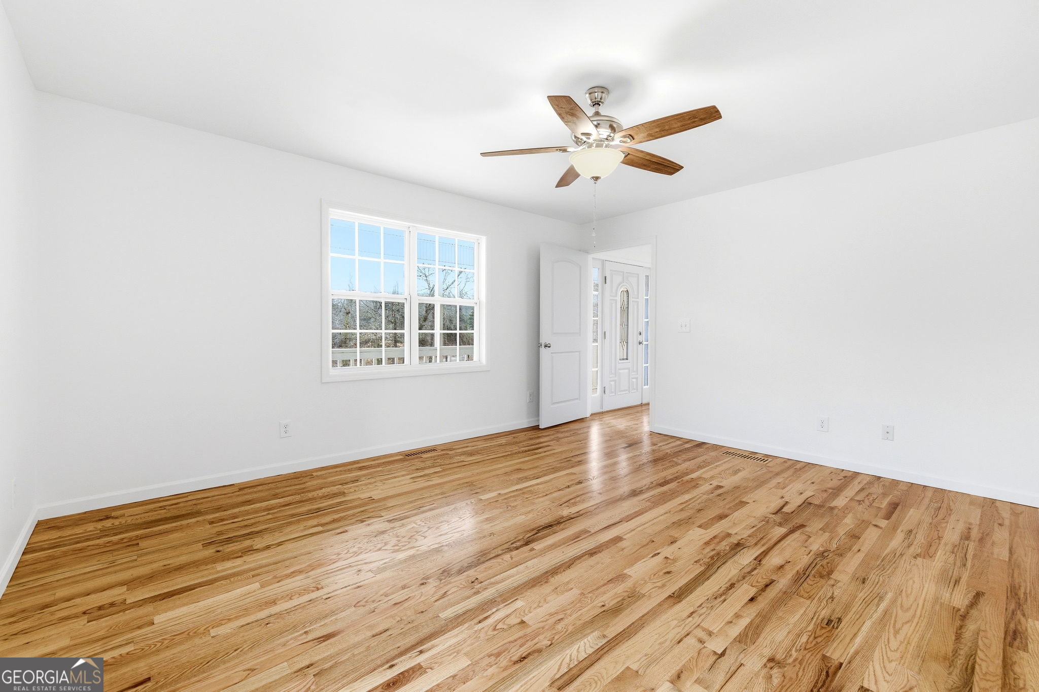 1429 Crumps Bridge Road Martin, GA 30557 - Photo 24 of 54 a view of empty room with wooden floor and fan