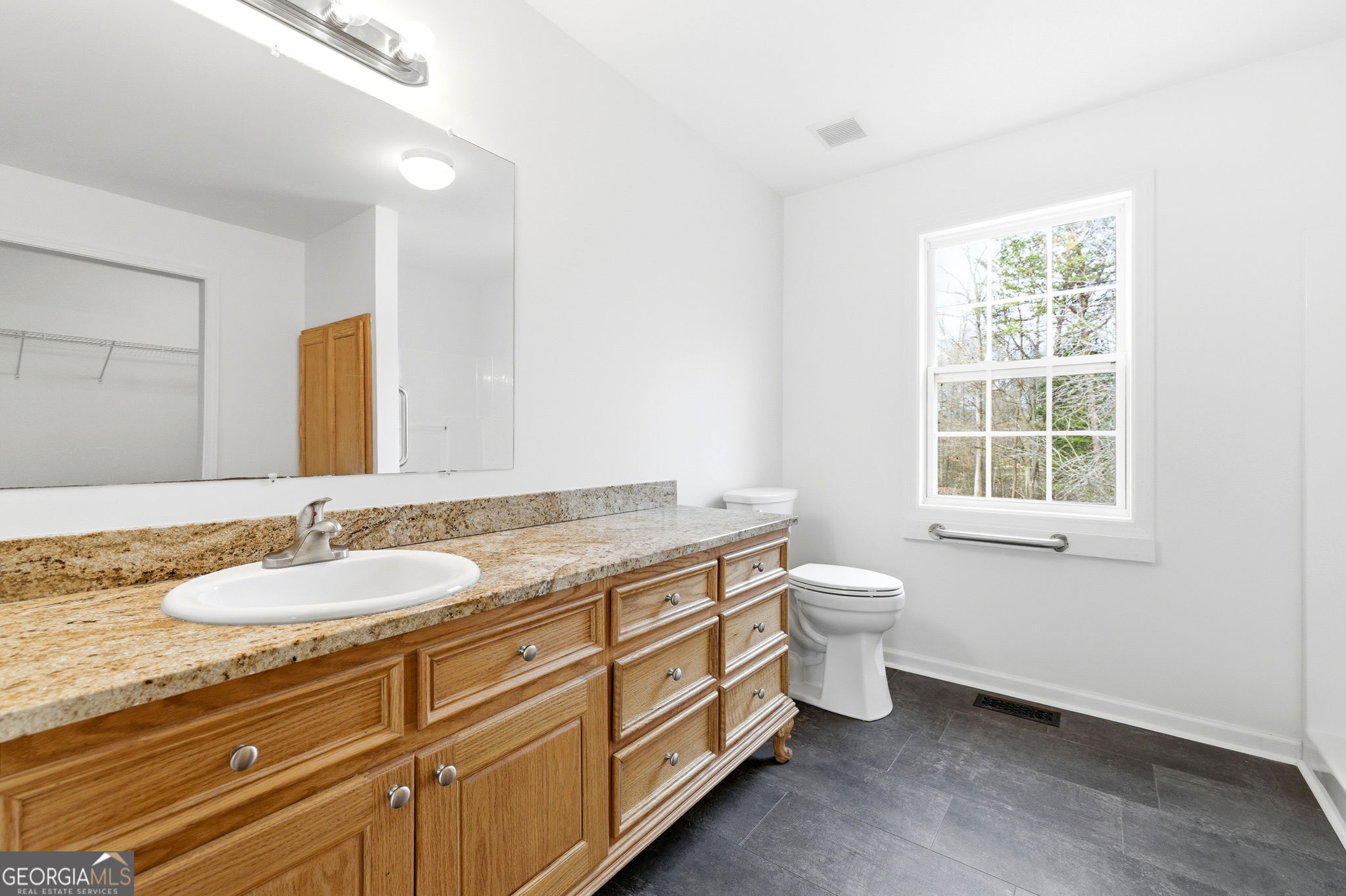 1429 Crumps Bridge Road Martin, GA 30557 - Photo 25 of 54 a bathroom with a granite countertop double vanity sink a mirror and a toilet