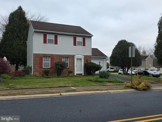 a view of a house with a yard and a street