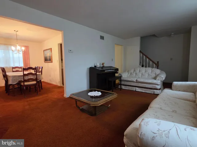 a living room with furniture and a pool table