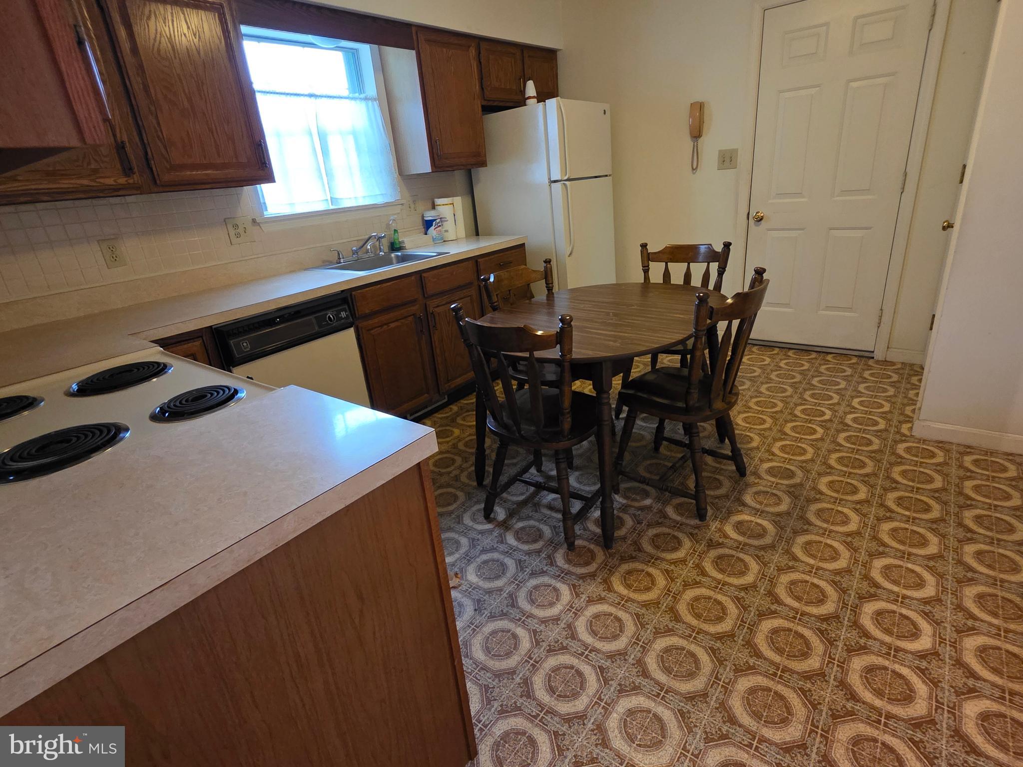 439 Coreopsis Drive Lancaster, PA 17602 - Photo 10 of 21 a kitchen with a sink a table and chairs in it