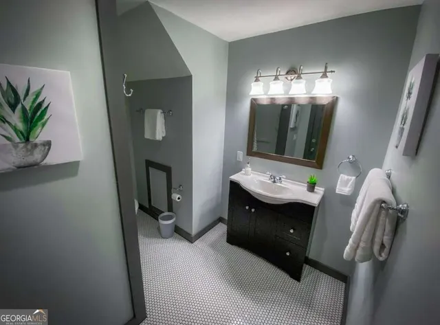 a bathroom with a sink and mirror