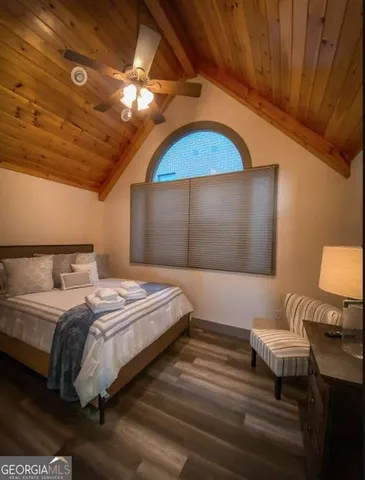 a bedroom with bed and a chandelier