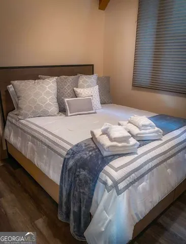 a bedroom with bed and window