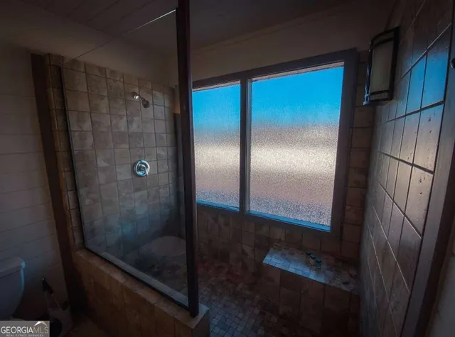 a bathroom with a glass shower door