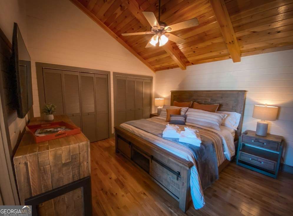 544 West Main Street Blue Ridge, GA 30513 - Photo 17 of 19 a bedroom with a bed and a flat screen tv