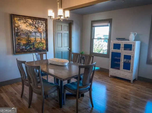a view of a dining room with furniture window and wooden floor