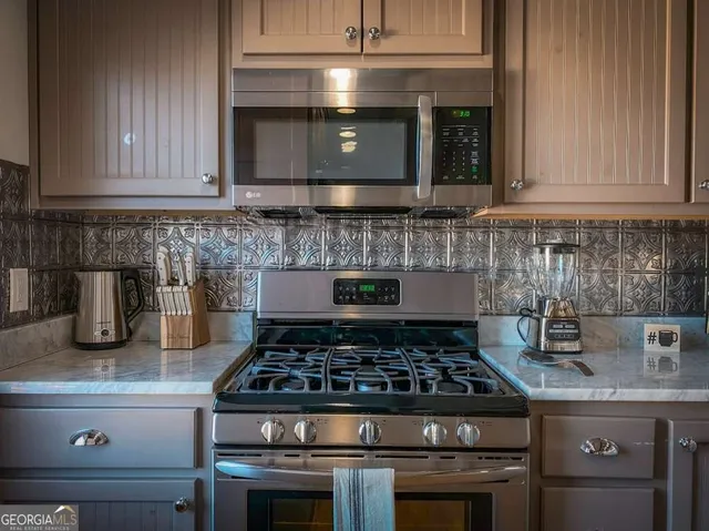 a stove top oven sitting inside of a kitchen