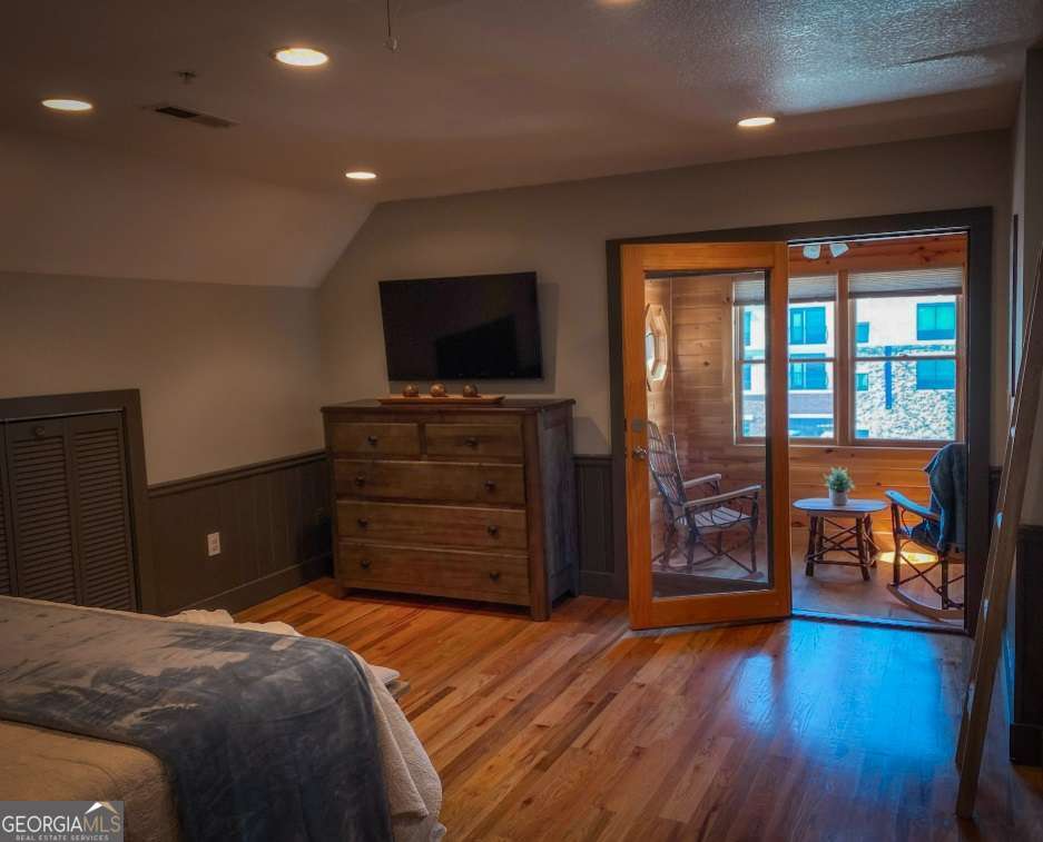 544 West Main Street Blue Ridge, GA 30513 - Photo 7 of 19 a bedroom with a bed and wooden floor
