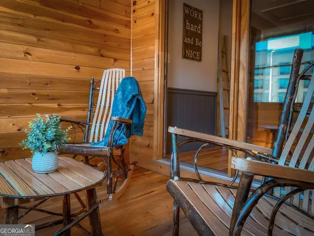 a view of a balcony with chairs and a potted plant