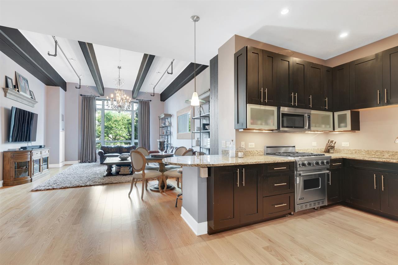 1500 Garden Street, Unit 2E Hoboken, NJ 07030 - Photo 1 of 1 a large kitchen with stainless steel appliances kitchen island granite countertop a large center island and a sink