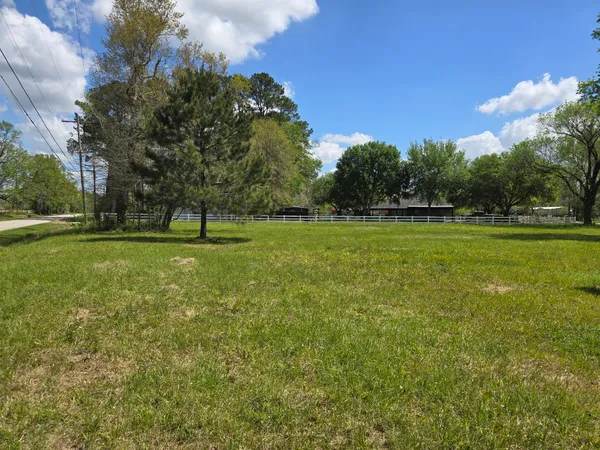 a view of tennis ground with trees in the background