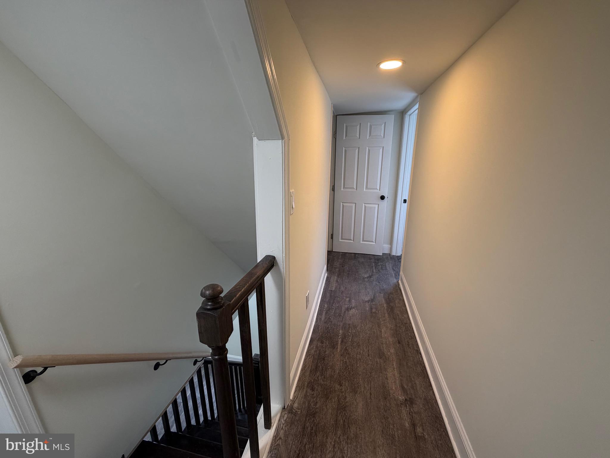 197 Main Street Hartly, DE 19953 - Photo 12 of 17 a view of a hallway with wooden floor and staircase
